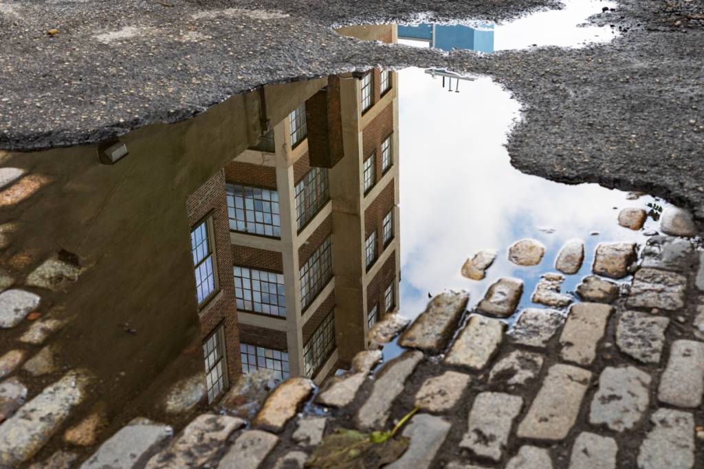 View of building in puddle of water