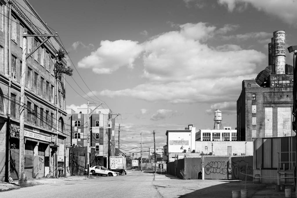 Black and white view of decaying commercial street.